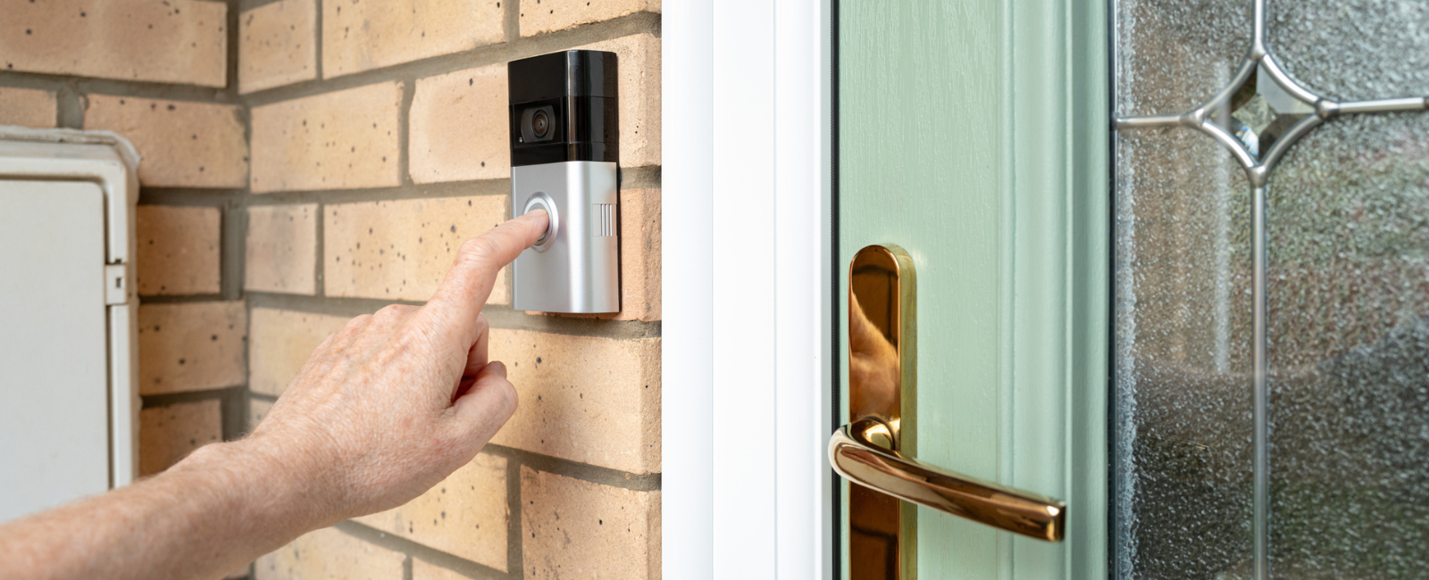 Hand ringing smart doorbell.